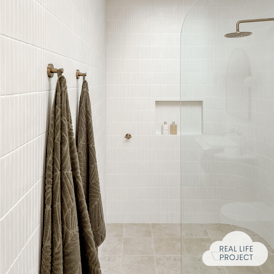 bathroom featuring white kit kat wall tiles