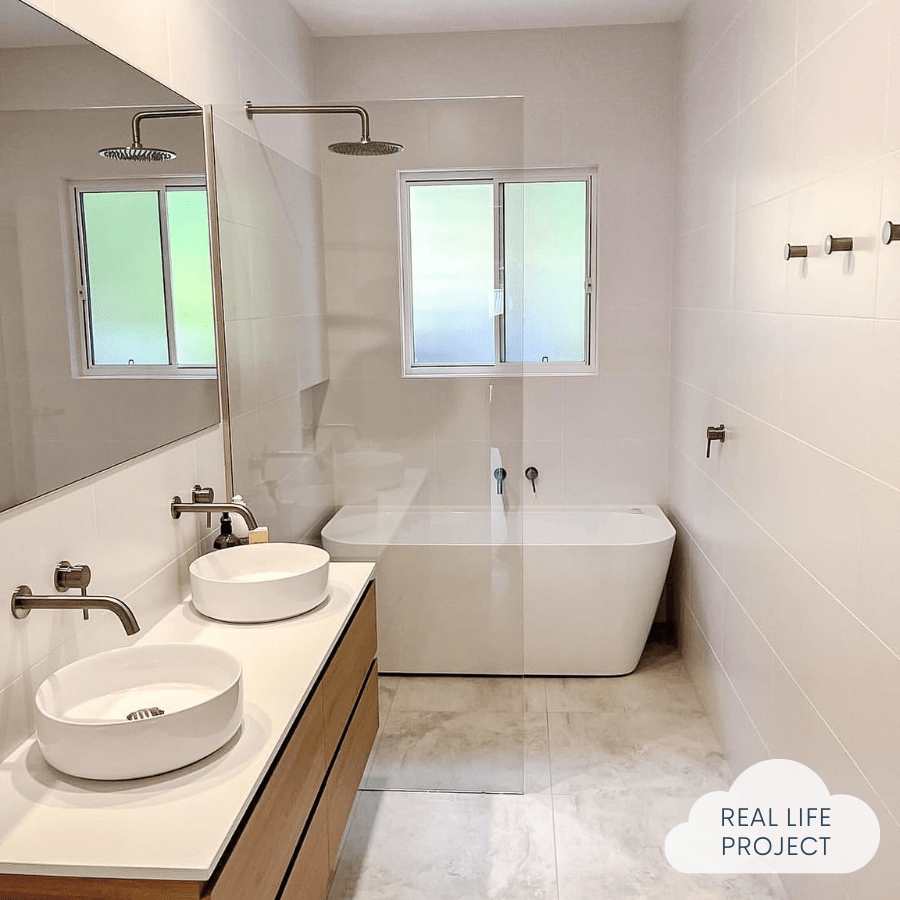 bathroom featuring matte white wall tiles and travertine floor tiles